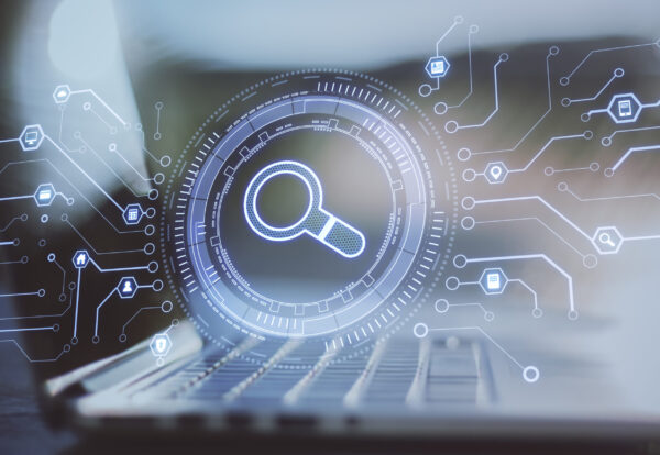 Laptop with abstract glowing digital business interface with search icon on blurry background. Double exposure